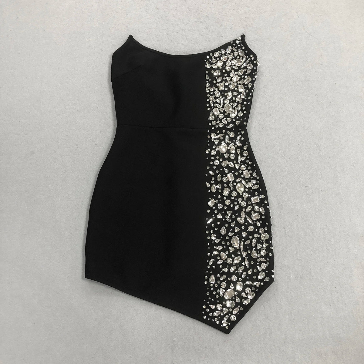 Black dress with a patterned side panel on a light gray background party mini little black dress