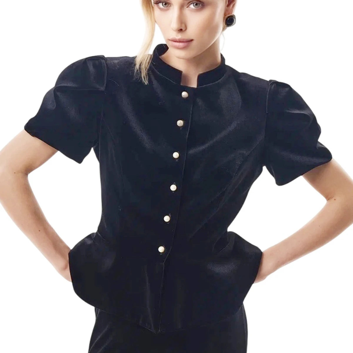 Woman wearing a black blouse with white buttons on a white background